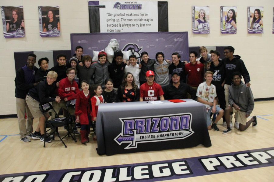 Senior Ricardo Correa poses with family and friends after signing with Central College. Photo via Lucy Hoffman.